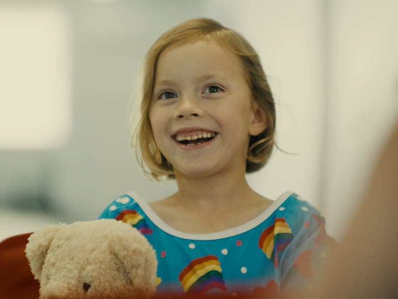 Child Smiling in Hero Wagon